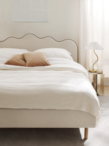Romy Upholstered Bed with Wavy Headboard